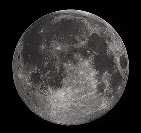 Full moon in the darkness of the night sky. It is patterned with a mix of light-tone regions and darker, irregular blotches, and scattered with varying sizes of impact craters, circles surrounded by out-thrown rays of bright ejecta.