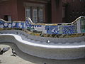 The unique shape of the serpentine bench enables the people sitting on it to converse privately, although the square is large. The bench is tiled and to dry up quickly after it rains, and to stop people from sitting in the wet part of the bench, small bumps were installed by Gaudí.