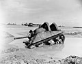 Mired M4 Sherman tank on a Normandy invasion beach, 12 June 1944.