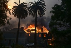 The Andrew McNally House, a historical landmark, burns during the Eaton Fire in Altadena, California, on January 8, 2025. Rampaging wildfires around Los Angeles have killed at least two people, officials said January 8 as terrifying blazes leveled whole streets, torching cars and houses in minutes.
More than 1,000 buildings have burned in multiple wildfires that have erupted around America's second biggest city, forcing tens of thousands of people from their homes. (Photo by Robyn Beck / AFP) (Photo by ROBYN BECK/AFP via Getty Images)