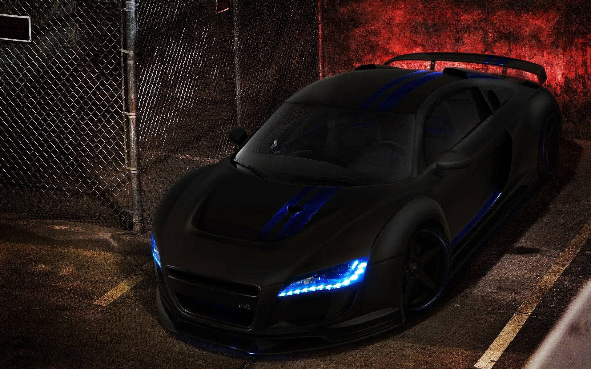 Schwarzer Sportwagen mit blauen Lichtern nachts neben einem Zaun geparkt. — Schwarze Sportwagen Wallpaper