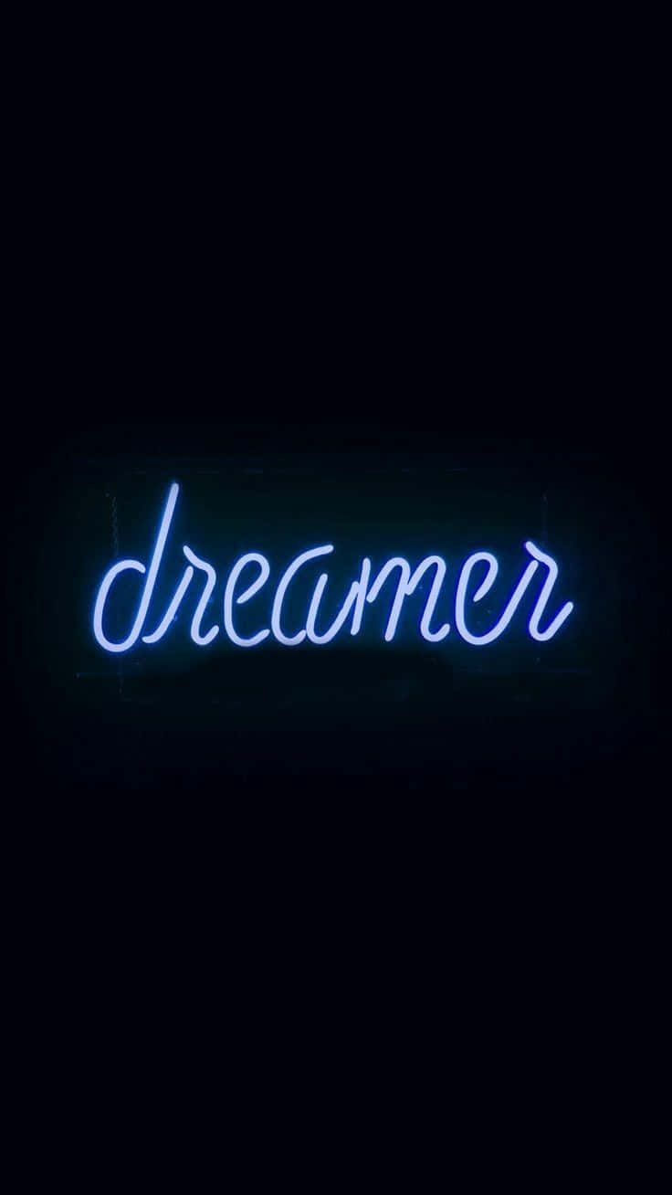 Une enseigne au néon avec le mot "dreamer" en cursive, brillant en bleu sur un fond sombre. — Esthétique Bleue Néon Fonds d'écran