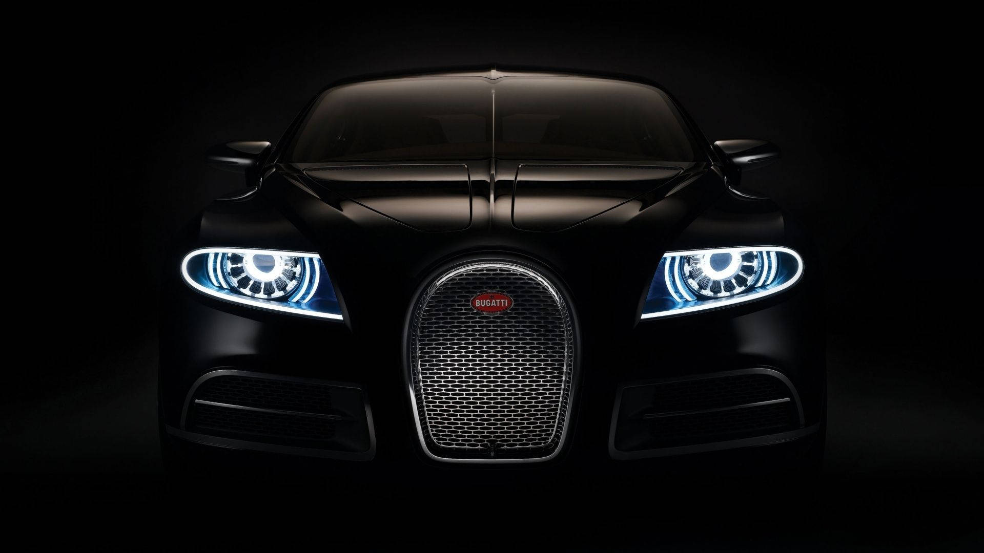 Frontansicht eines schwarzen Bugatti-Supersportwagens mit leuchtenden Scheinwerfern im Dunkeln. — Schwarze Sportwagen Wallpaper