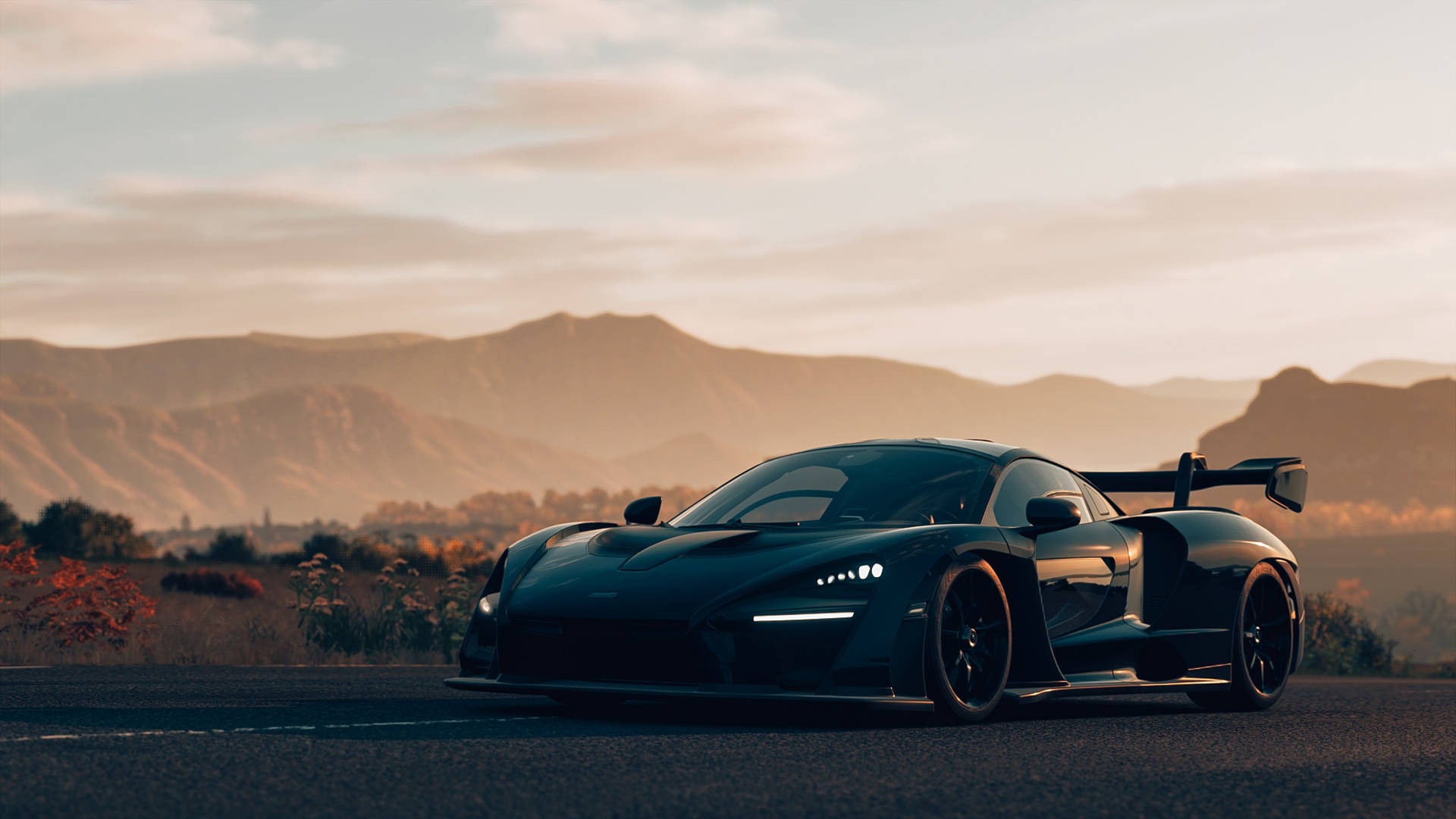 Schwarzer Hypercar auf Wüstenstraße bei Sonnenuntergang mit Bergkulisse — Schwarze Sportwagen Wallpaper
