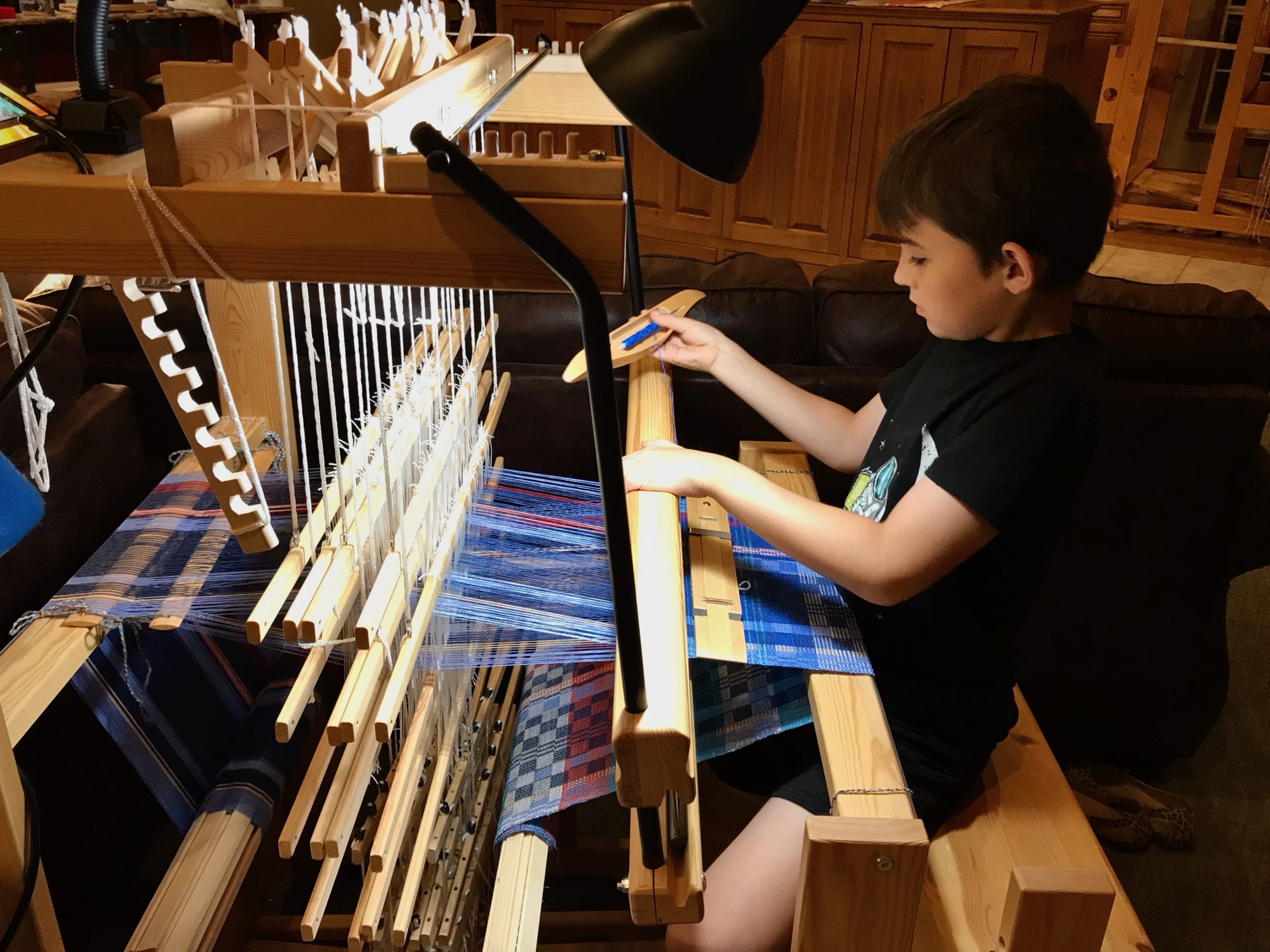Eight-year-old weaver on the Glimakra Julia loom. 2-block twill.