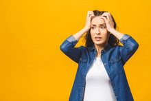 Woman with hands on her head and a frustrated look on her face.