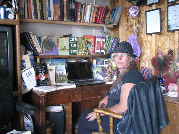 Author Kaye Lynne Booth sitting at a desk