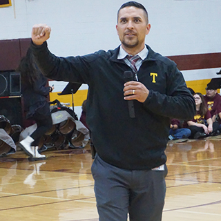 Tolleson Union High School representative with microphone in the gym