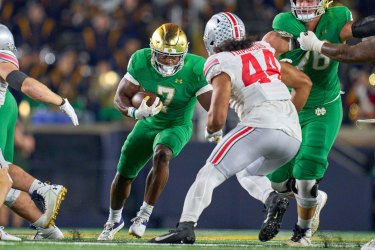 Notre Dame Fighting Irish running back Audric Estime (7) battles with Ohio State Buckeyes