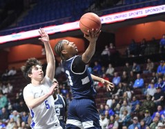 HPHSStaffordBB4 Hartford Public's Jaiden Booth takes the ball to the hoop as Stafford's Stephen Tantillo (5) defends in the Division V state championship boys basketball game Sunday morning at Mohegan Sun. Stafford won its first state boys basketball title in 73 years, 64-59. (Photo by Lori Riley)