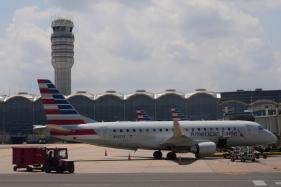 Iran_US_Jet_Fuel_2_897 FILE – An American Eagle plane is parked at a gate at the Ronald Reagan Washington National Airport in Arlington, Va., June 29, 2026. (AP Photo/Carolyn Kaster, File)