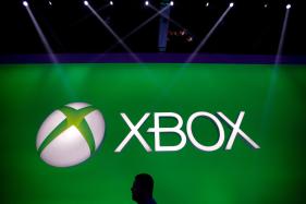 Microsoft_Xbox_Layoffs_51131 A man walks past the Xbox logo at the Microsoft booth.