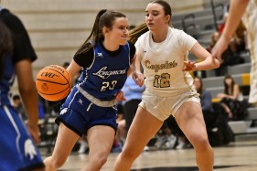 DCC-L-LongMonGirls-2-3-03 Longmont's Olivia Schaefer, left, drives to the basket around Monarch's Sidney Miller, right, during their game Tuesday night. (Alissa Noe/BoCoPreps.com)