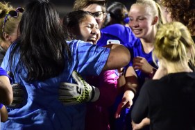 DCC-L-BARRON2 Longmont goalkeeper Natalie Barron celebrates with teammates after big performance in the Trojans' win over Holy Family in the Class 3A state quarterfinals on Tuesday. (Brent W. New/BoCoPreps.com)