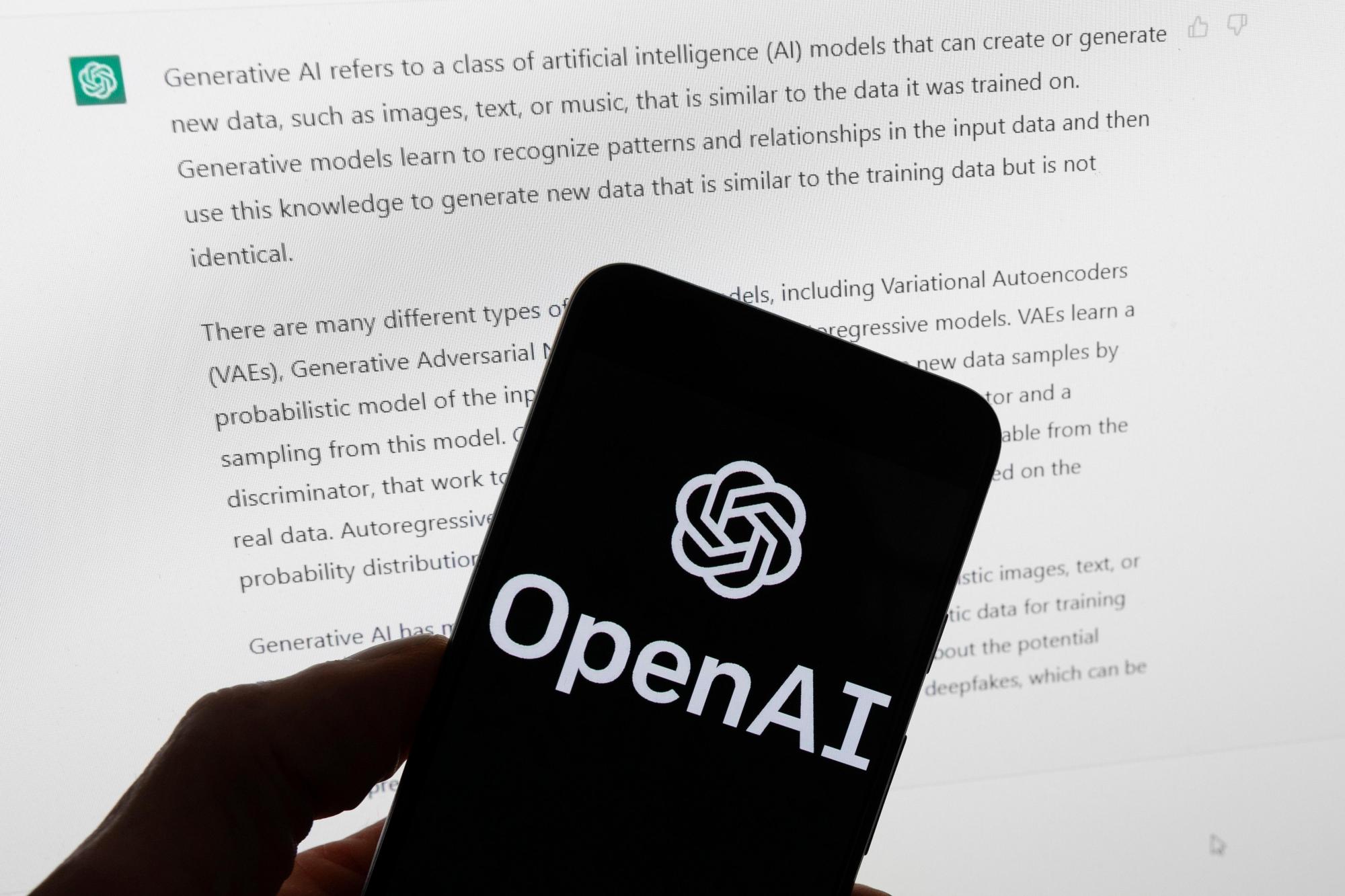 ChatGPT-Ads_24182 FILE – The OpenAI logo is displayed on a mobile phone in front of a computer screen with output from ChatGPT, March 21, 2023, in Boston. (AP Photo/Michael Dwyer, File)