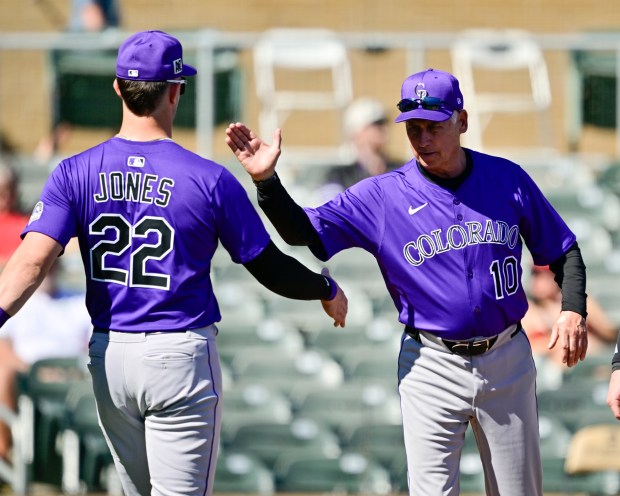 Colorado Rockies manager Bud Black greets Colorado Rockies outfielder Nolan...