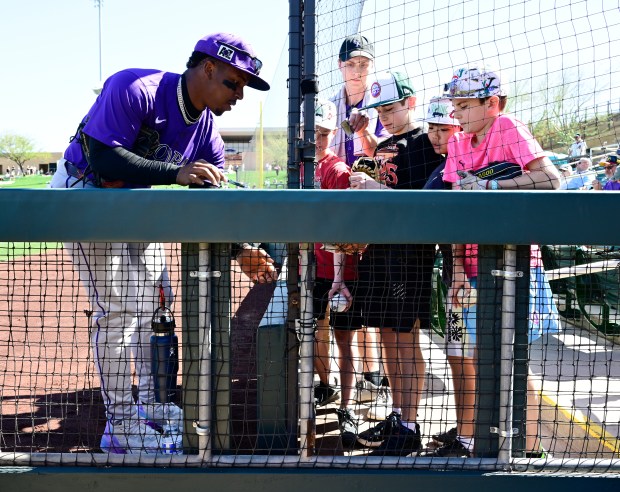 Colorado Rockies second base Adael Amador (1) signs autographs for...