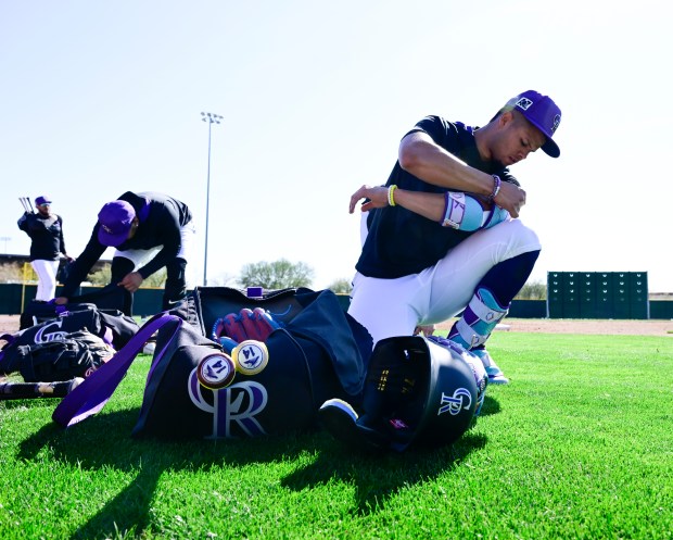 Colorado Rockies shortstop Ezequiel Tovar (14) adjusts his gear in...