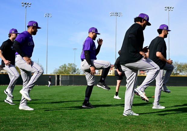 Colorado Rockies pitchers stretch during training camp at Salt River...