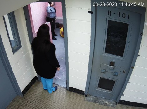 TDP-L-Burch1-01 Huerfano County sheriff's Capt. Lea Vigil makes a circular motion by her head as she stands over inmate Michael Burch on March 28, 2023. (Photo provided by Rathod Mohamedbhai law firm)