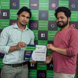 Doonite academy student receiving a 4 month digital marketing certificate from trainer