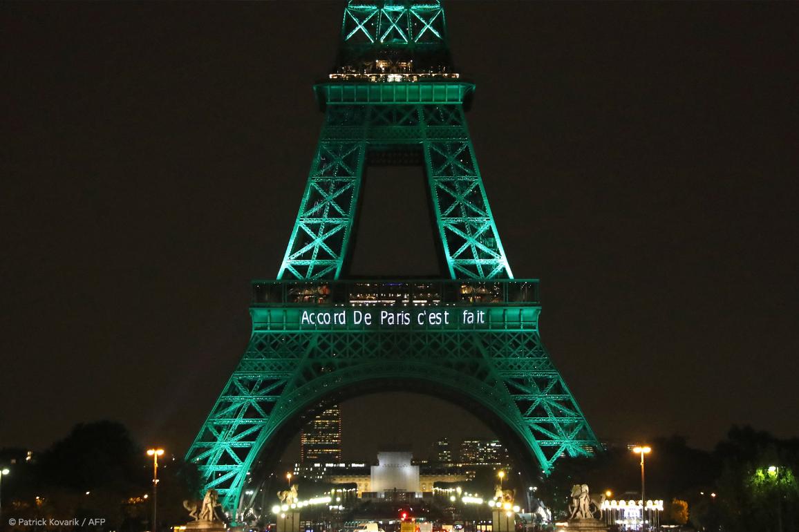 The Eiffel Tower (Tour Eiffel) is illuminated with the lettering reading 'The Paris accord is done' in Paris on November 4, 2016, to celebrate the first day of the application of the Paris COP21 climate accord.