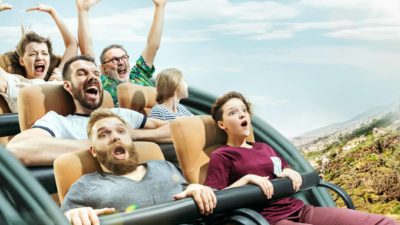 Scared looking people on a rollercoaster ride representing the volatile Mineral Resources share price in 2022