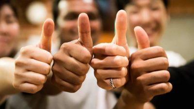 A team of people giving the thumbs up sign representing APA and Wesfarmers doing a deal to study green hydrogen transport using an APA gas pipeline