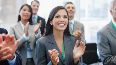 A group of businesspeople clapping.