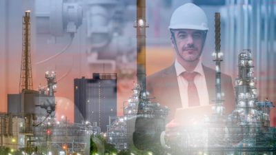 Gas and oil plant with a inspector in the background.