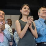 Successful group of people applauding in a business meeting and looking very happy.