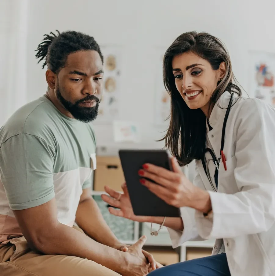 A doctor and patient review information together on a tablet