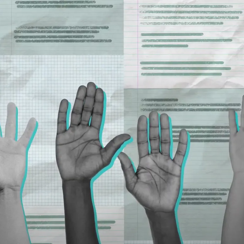 Four raised hands of different skin tones over a background of lined and graph paper