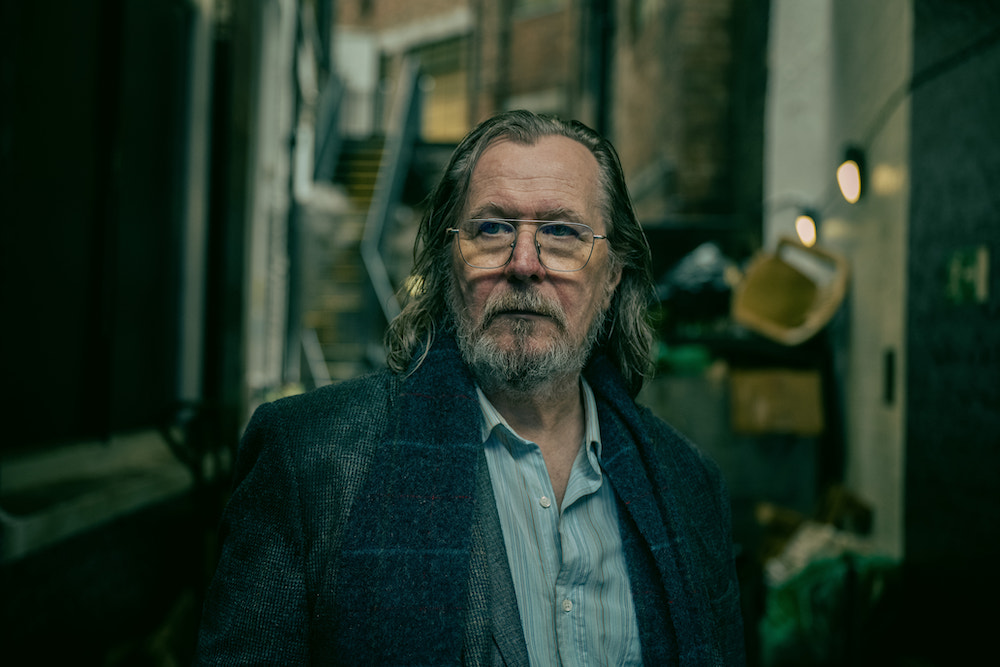 'Slow Horses' stars Gary Oldman as Jackson Lamb, shown here wearing a gray coat with a navy scarf