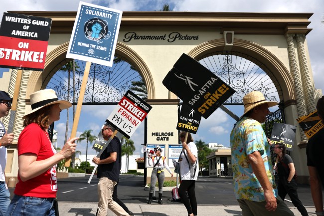 LOS ANGELES, CALIFORNIA - SEPTEMBER 18: Strike captain SAG-AFTRA member Cari Ciotti (C) calls out instructions as striking WGA (Writers Guild of America) members picket with striking SAG-AFTRA members outside Paramount Studios on September 18, 2023 in Los Angeles, California. The Writers Guild of America and Alliance of Motion Picture and Television Producers (AMPTP) are set to meet for a new round of contract talks this week in the four-months long writers strike. (Photo by Mario Tama/Getty Images)