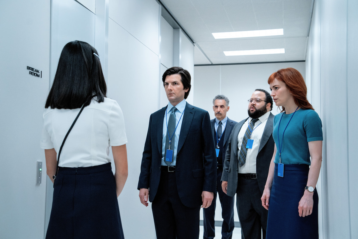 'Severance' Season 2 Episode 1, with Mark (Adam Scott), Helly (Brit Lower), Dylan (Zach Cherry), and Irving (John Turturro) standing in the white hallway outside the Break Room