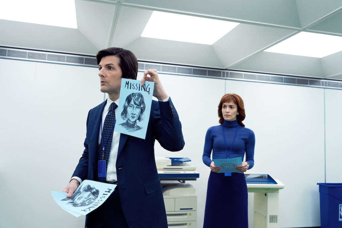 Adam Scott and Britt Lower in 'Severance' Season 2 Episode 3, shown in the office holding up a sketch of Ms Casey on a Missing flier