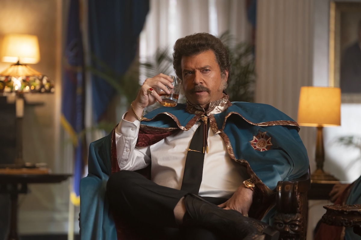 Danny McBride in 'The Righteous Gemstones' Season 4, shown sipping whiskey, seated, wearing a turquoise cloak with gold trim