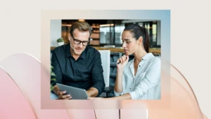 a man and a woman looking at a laptop