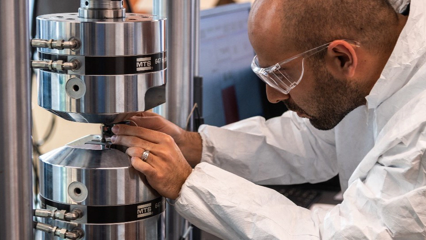 Man in safety glasses uses machine