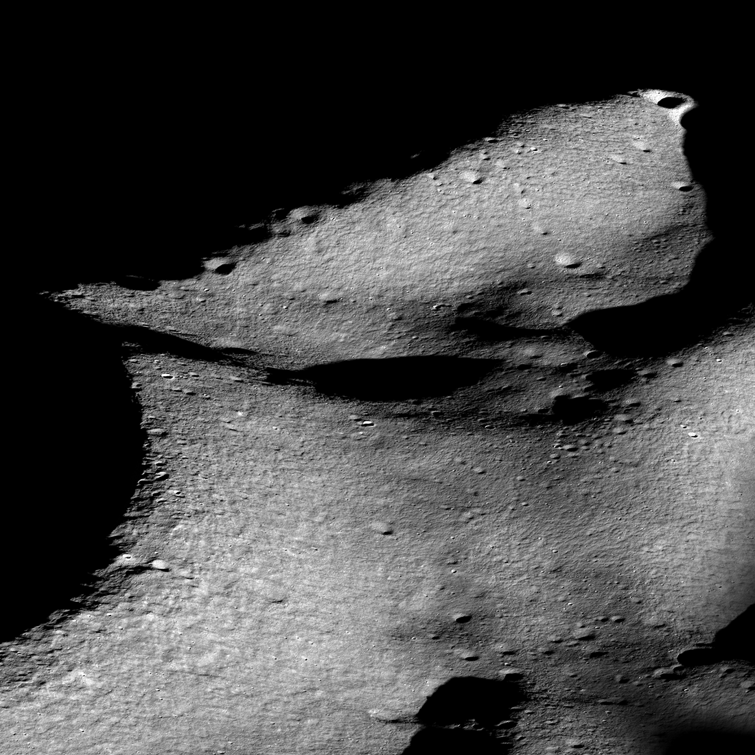 Oblique view of the rim of Shackleton crater (on the left) and the Shackleton - de Gerlache ridge that runs from middle left to upper right, seen i...