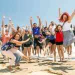 Interns visiting Wallops Flight Facility jumping in a fun photo at the Wallops Island Beach