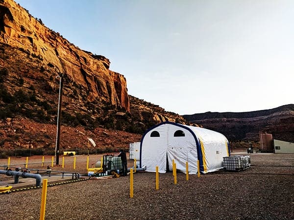 Photo of a tented Saltworks zero liquid discharge evaporative crystallizer pilot in a desert landscape