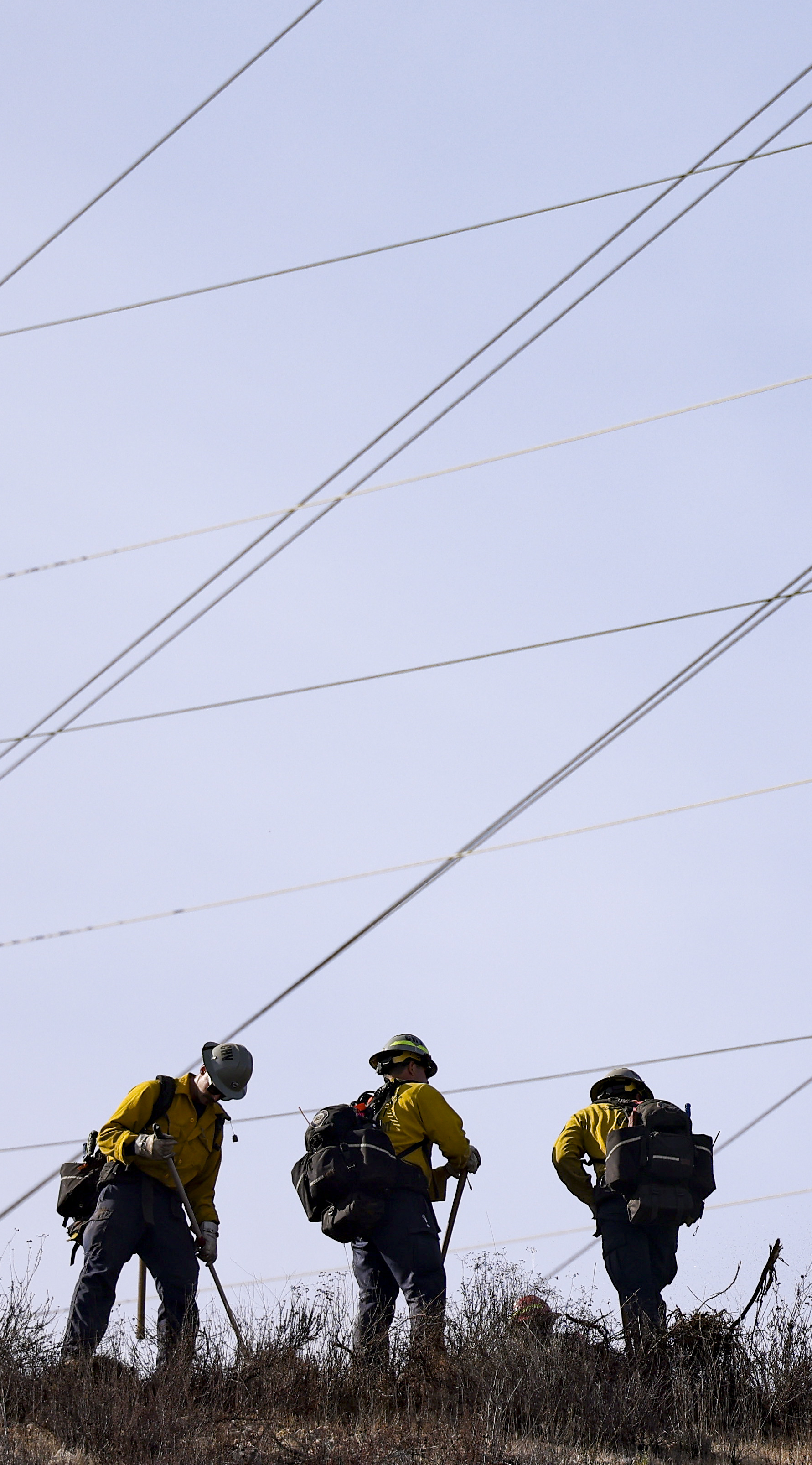 Firefighters work to contain a fire close to structures on Friars Road on Tuesday, Jan. 21, 2025 in San Diego, CA. (Meg McLaughlin / The San Diego Union-Tribune)