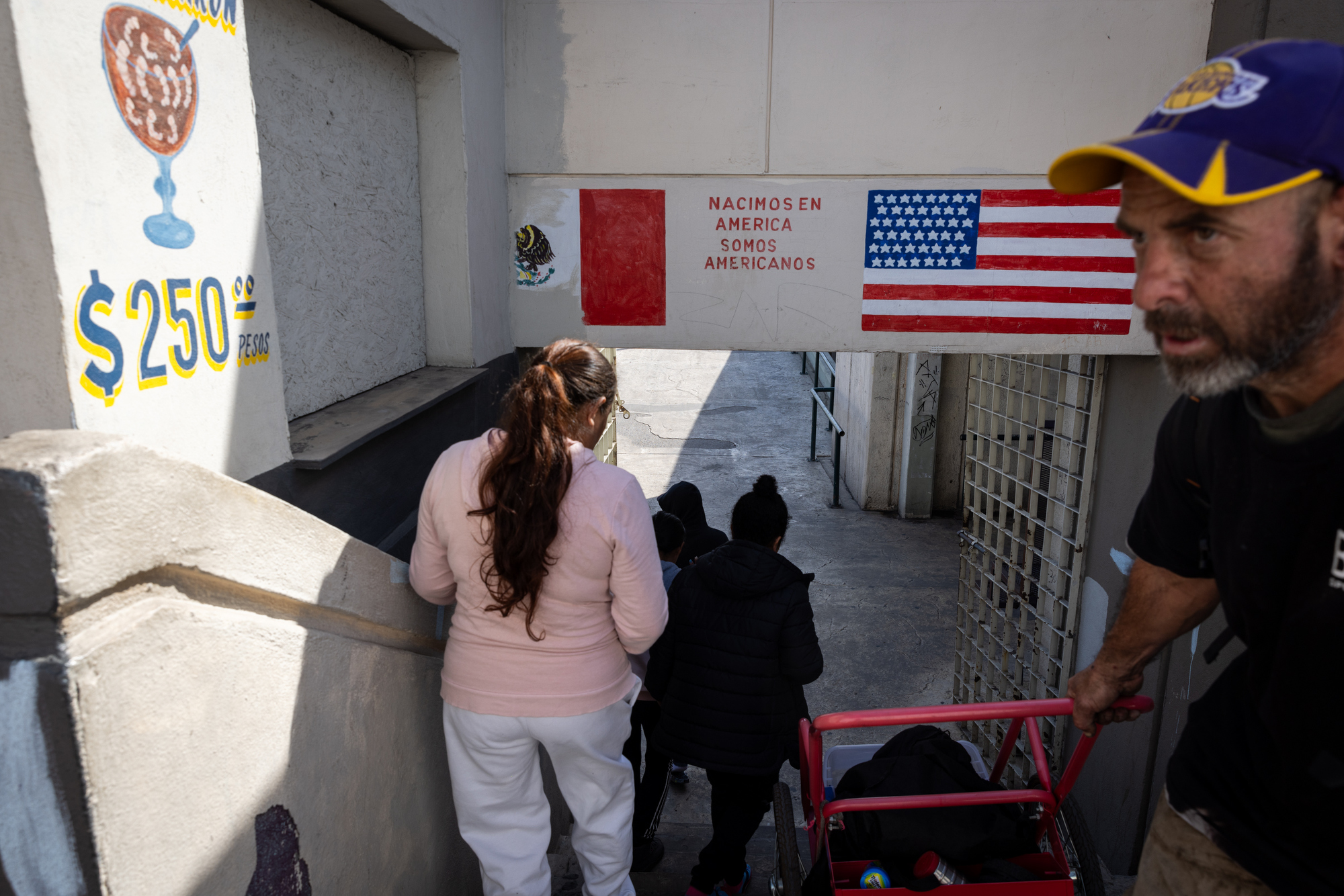 A group of migrants staying at Juventud 2000 shelter head to Pedwest Port of Entry to try to understand what is happening after receiving news that their CBP One appointments were cancelled on Monday, Jan. 20, 2025 in Tijuana, Mexico. (Ana Ramirez / The San Diego Union-Tribune)