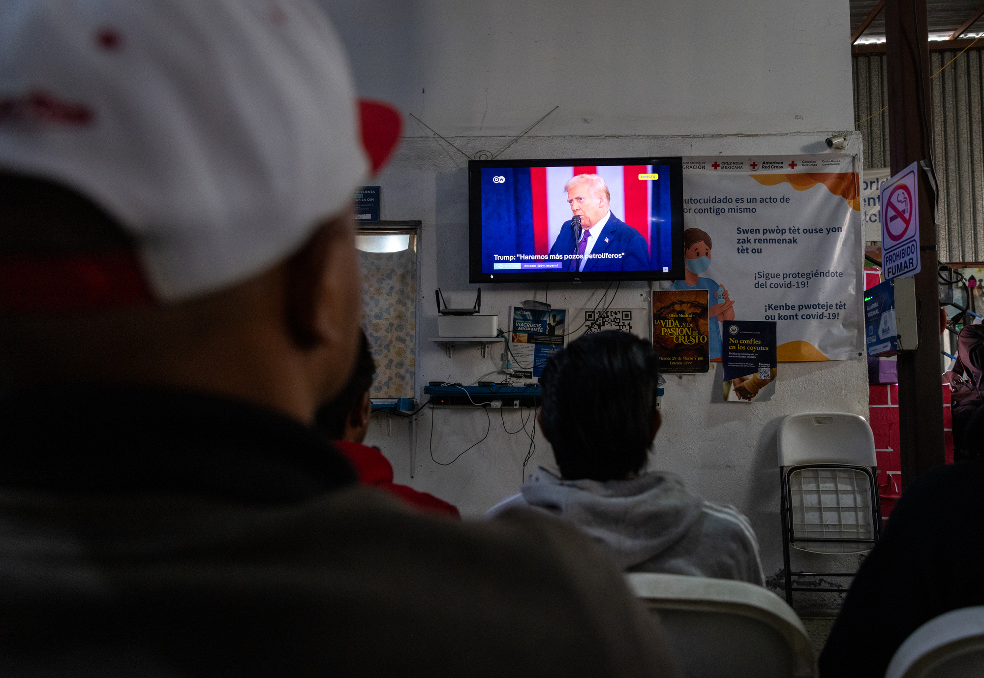 Migrants staying at Juventud 2000 shelter watch President Donald Trump's inaugural speech on television on Monday, Jan. 20, 2025 in Tijuana, Mexico. (Ana Ramirez / The San Diego Union-Tribune)