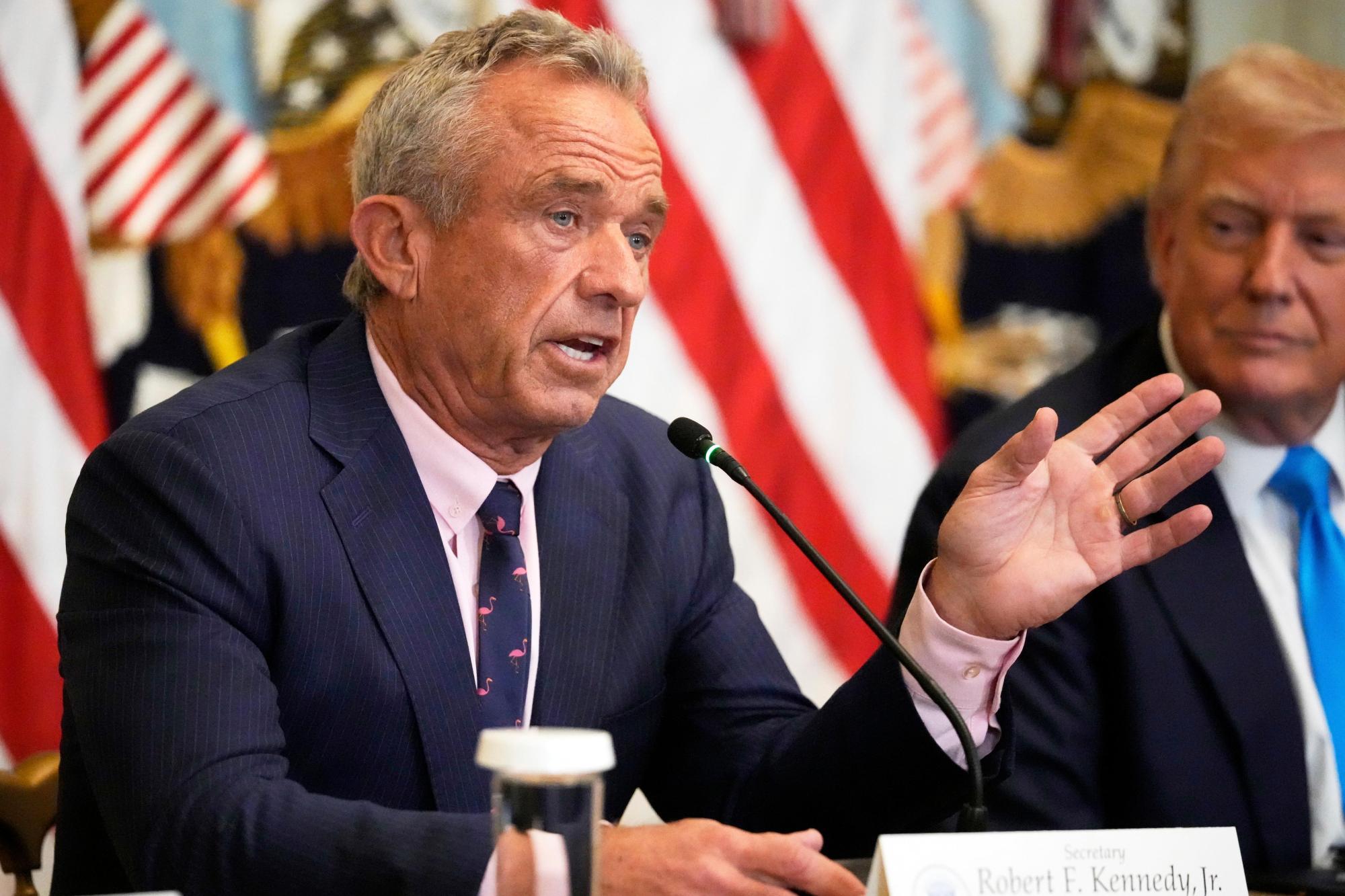 Trump_97023 Health and Human Services Secretary Robert F. Kennedy Jr. speaks as President Donald Trump listens at an event to promote his proposal to improve Americans’ access to their medical records in the East Room of the White House, Wednesday, July 30, 2025, in Washington. (AP Photo/Mark Schiefelbein)