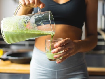 Woman pouring green juice