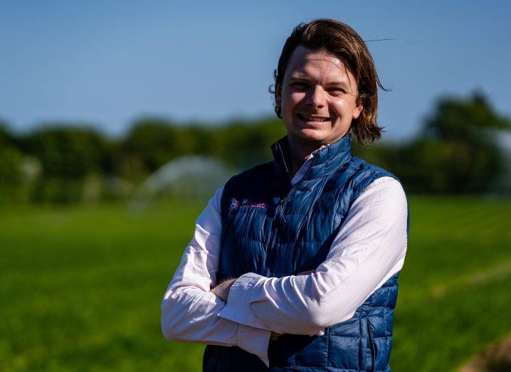 Headshot of Maurice Bryson, founder of Silicate, standing in a green field with his arms folded.