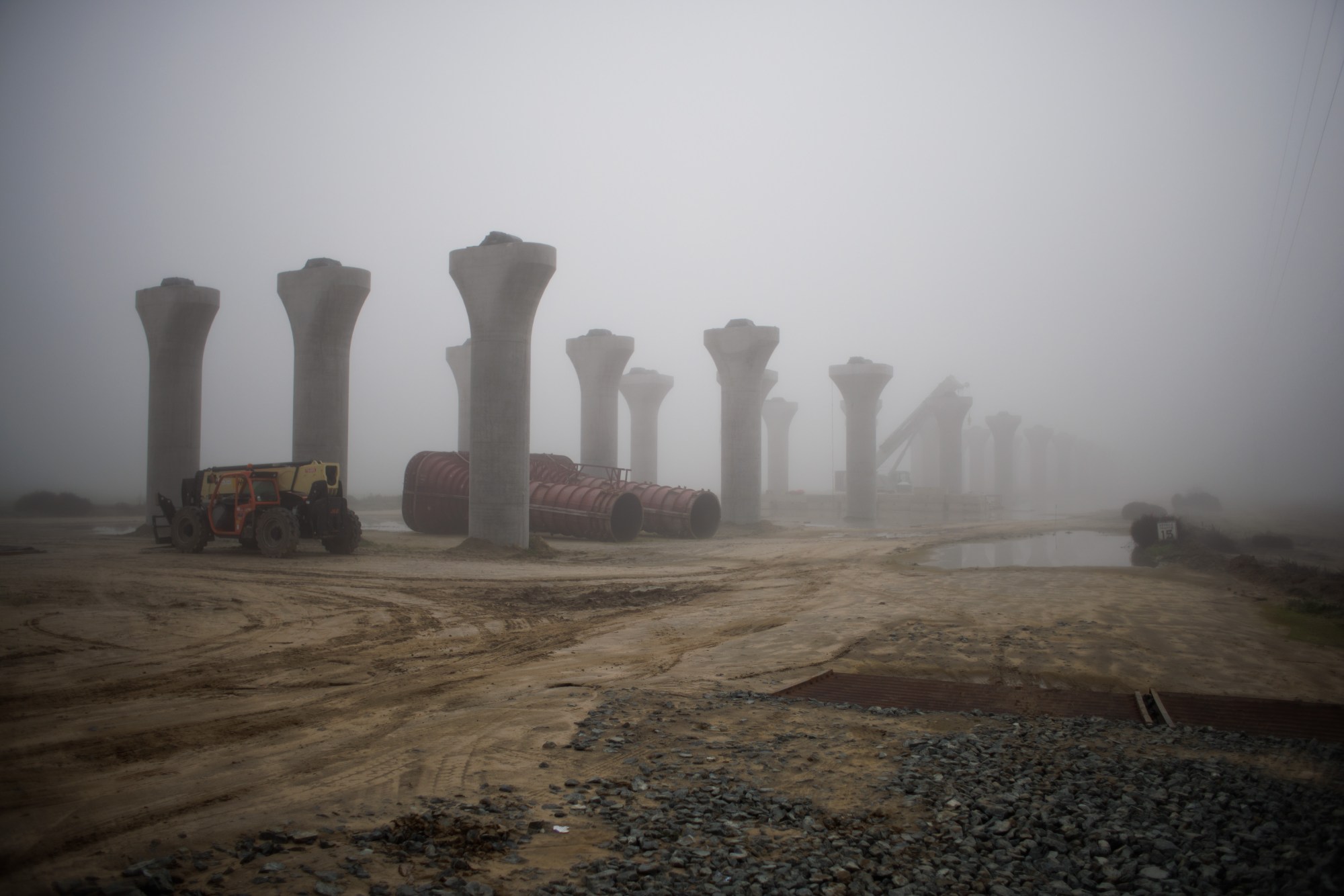 SJM-L-HIGHSPEED-0702-2 Support pillars for the state’s controversial High-Speed rail are seen in the morning fog early in 2022 in Hanford, Calif. The California High-Speed Rail Authority Board of Directors has approved the final environmental document for the 38-mile segment between Palmdale and Burbank, the last piece of the planned route from San Francisco to Los Angeles.(Dai Sugano/Bay Area News Group)